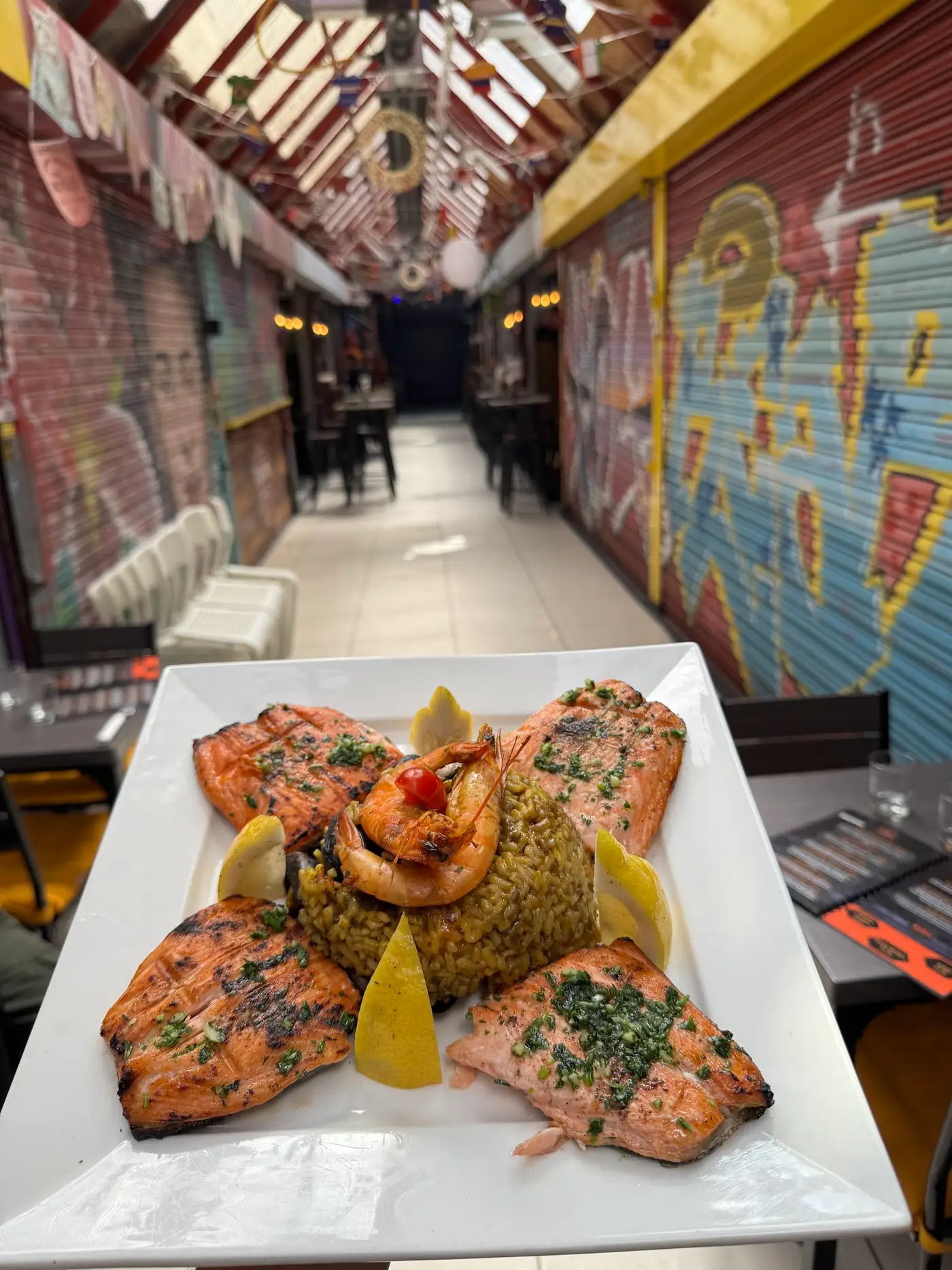 Plated salmon and prawns in a London market arcade